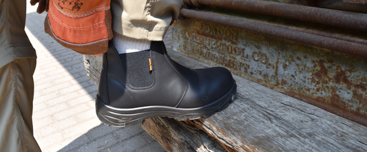 CSA and ASTM approved composite toe black work boot in industrial outdoor setting