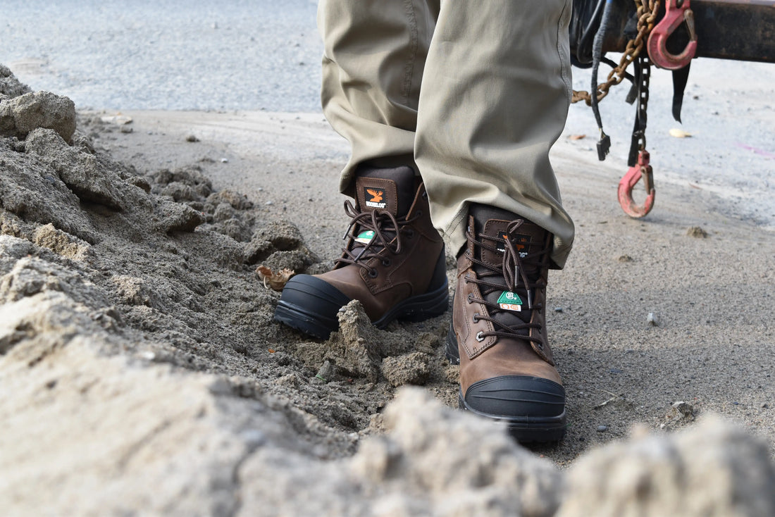 MooseLog Worker Wearing CSA Green Triangle and White Omega Symbol Work Boots