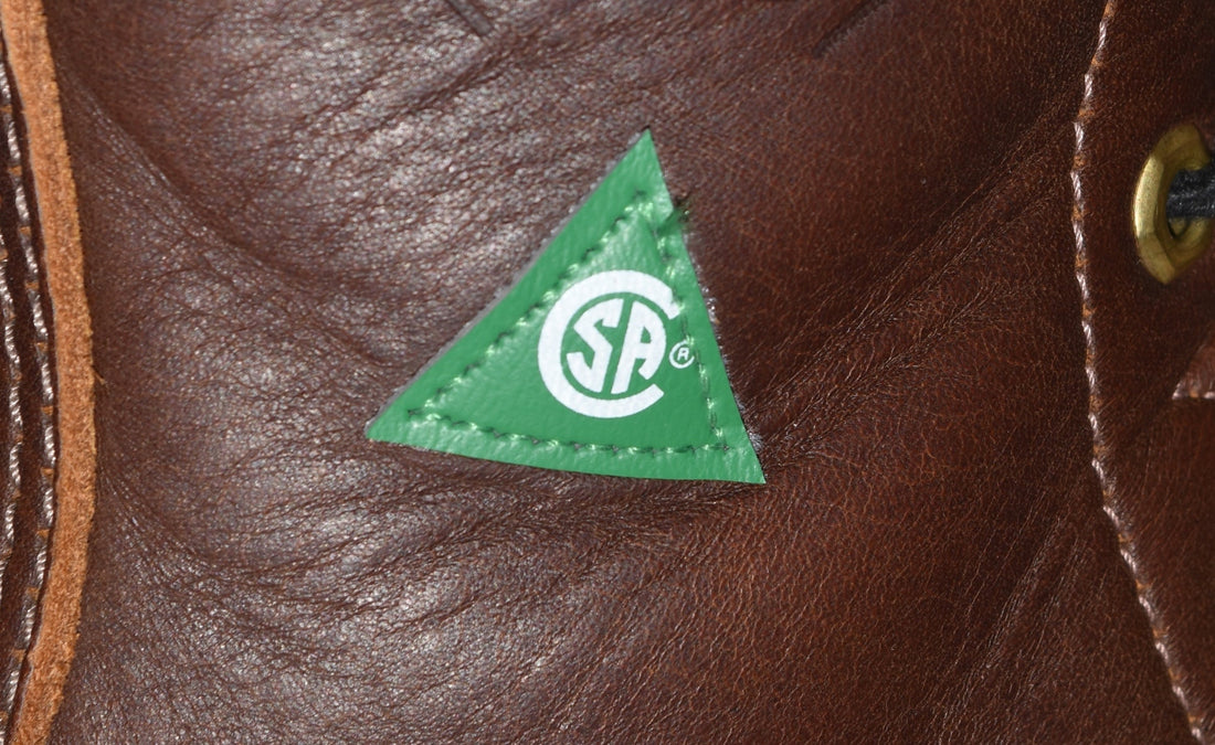 Green CSA safety label stitched on brown leather work boot