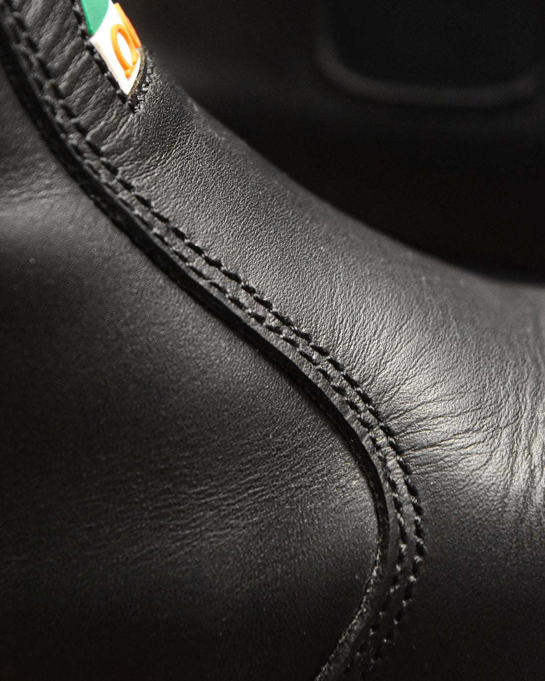 Close-up of black leather composite toe work boot with detailed stitching