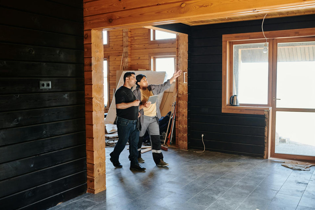 Two construction workers inspecting a wooden interior during a building project