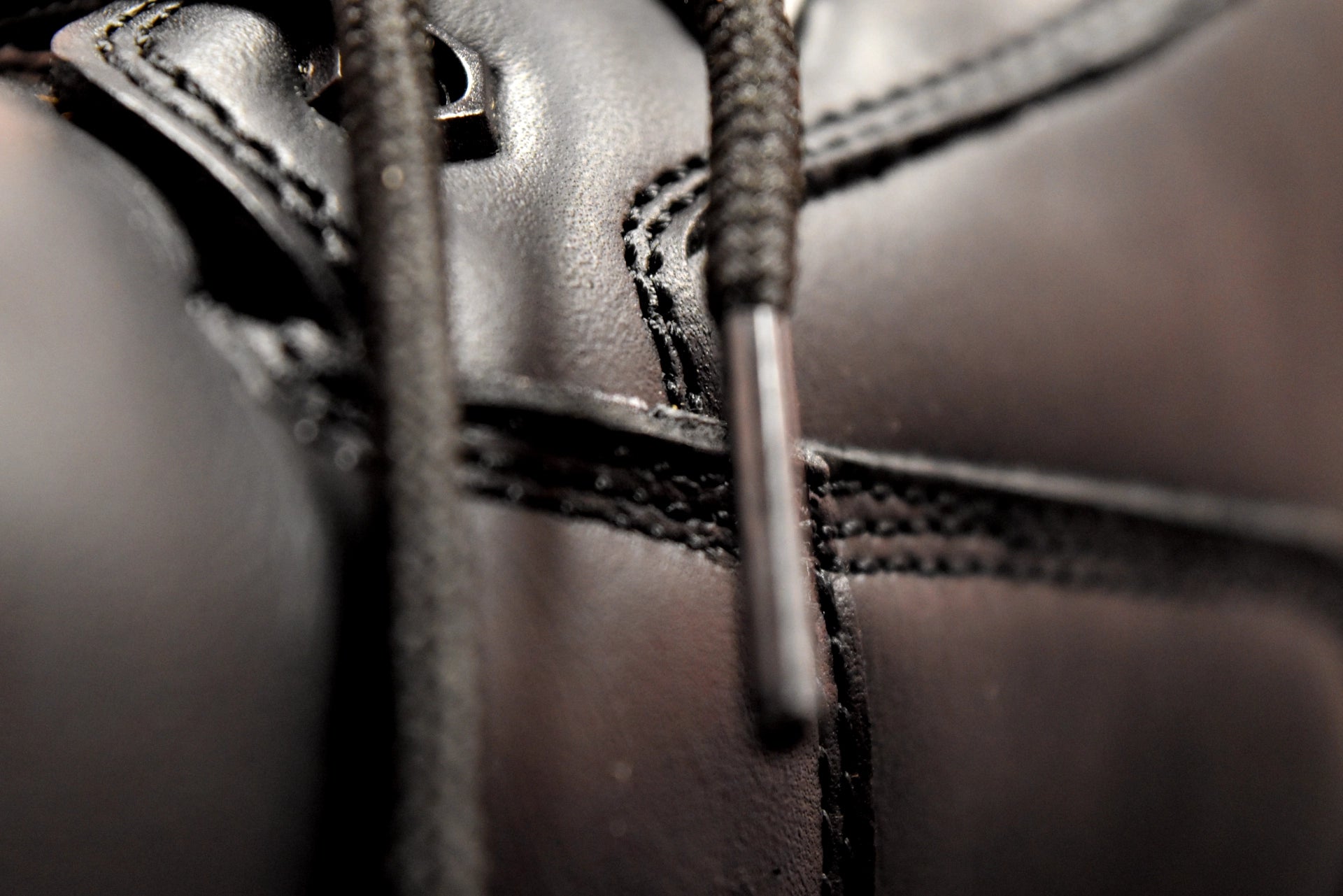 Close-up of a black leather boot with laces