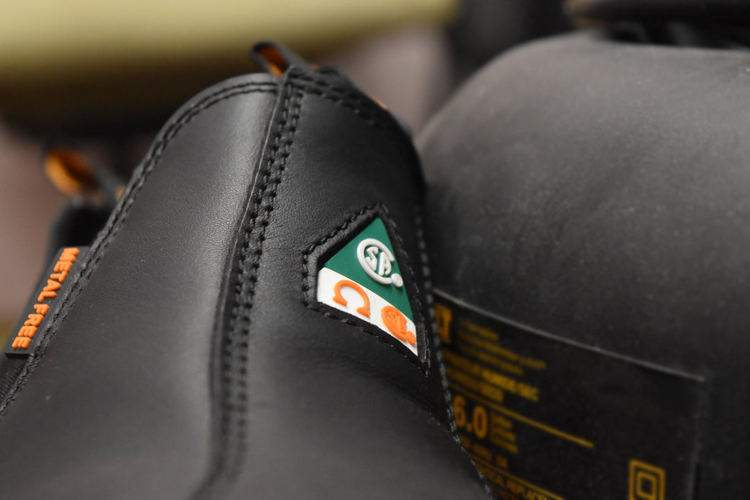Close-up of a black boot with a brand logo on a blurred background