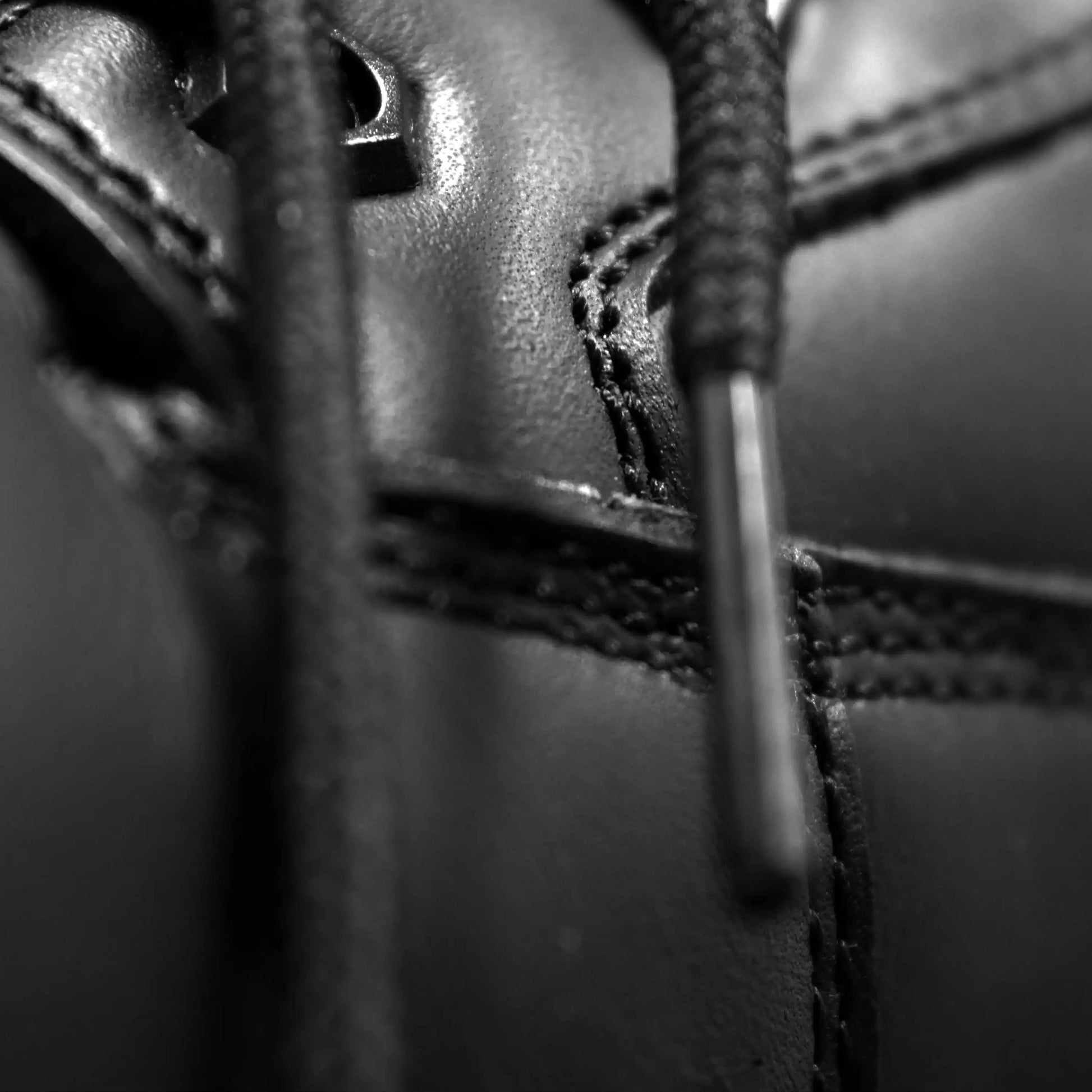 Close-up of a black leather shoe with laces