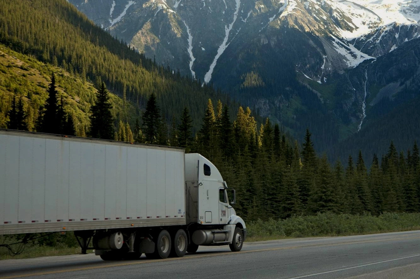 White truck in mountainous roads scenery
